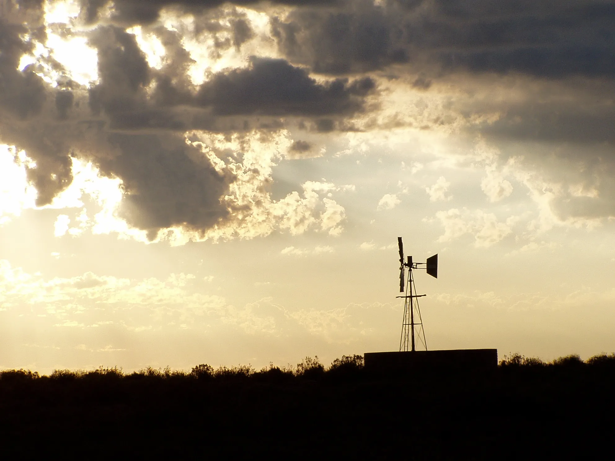 Sunset over the Great Karoo near Sutherland with a multi-bladed wind pump